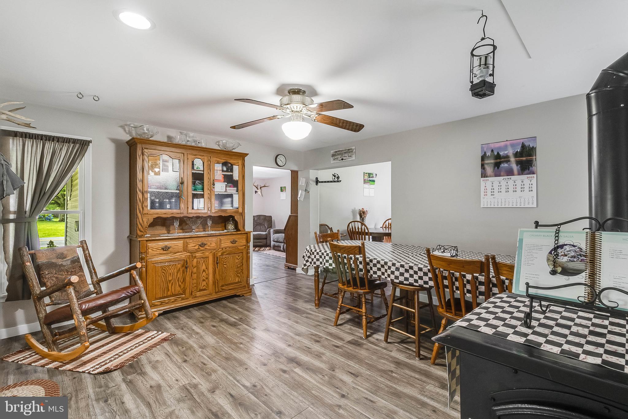 5634 Pearsons Corner Road Dover, DE 19904 - Photo 9 of 40 a living room with furniture a dining table and with wooden floor