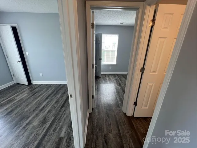 a view of a hallway and wooden floor