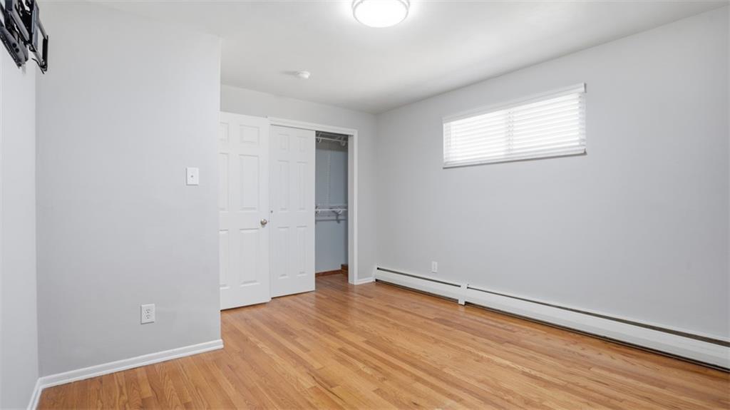 245 Conway Wallrose Road Freedom, PA 15042 - Photo 25 of 48 an empty room with wooden floor and windows