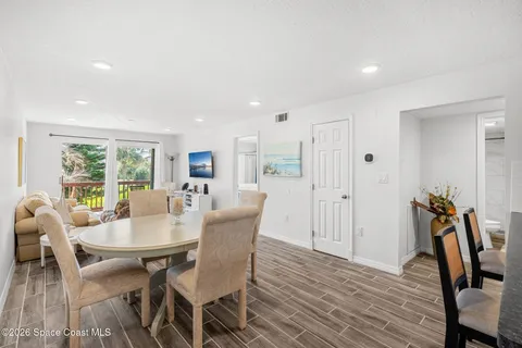 a view of a dining room with furniture and wooden floor