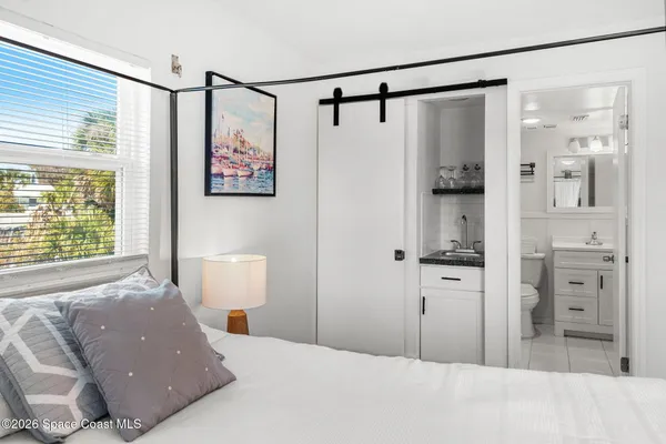 a bedroom with a bed and a window