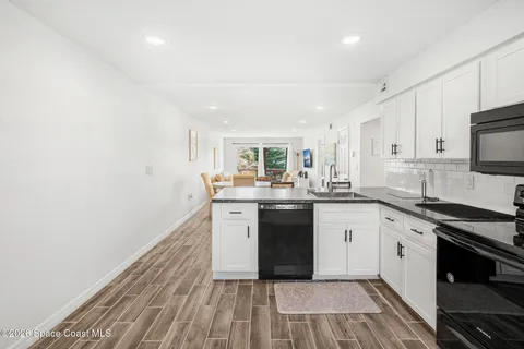 a kitchen with stainless steel appliances granite countertop a refrigerator microwave and sink