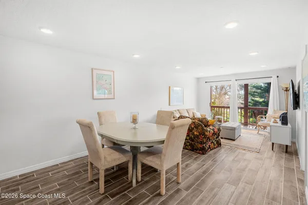 a view of a dining room with furniture and wooden floor