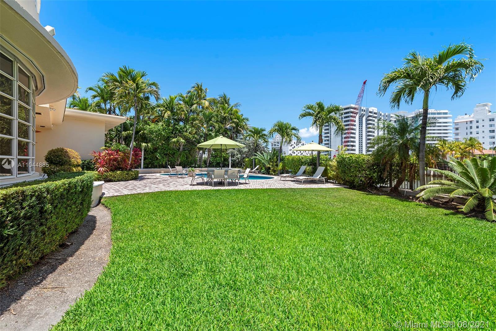 2995 Flamingo Drive Miami Beach, FL 33140 - Photo 20 of 54 a view of a garden with a building in the background