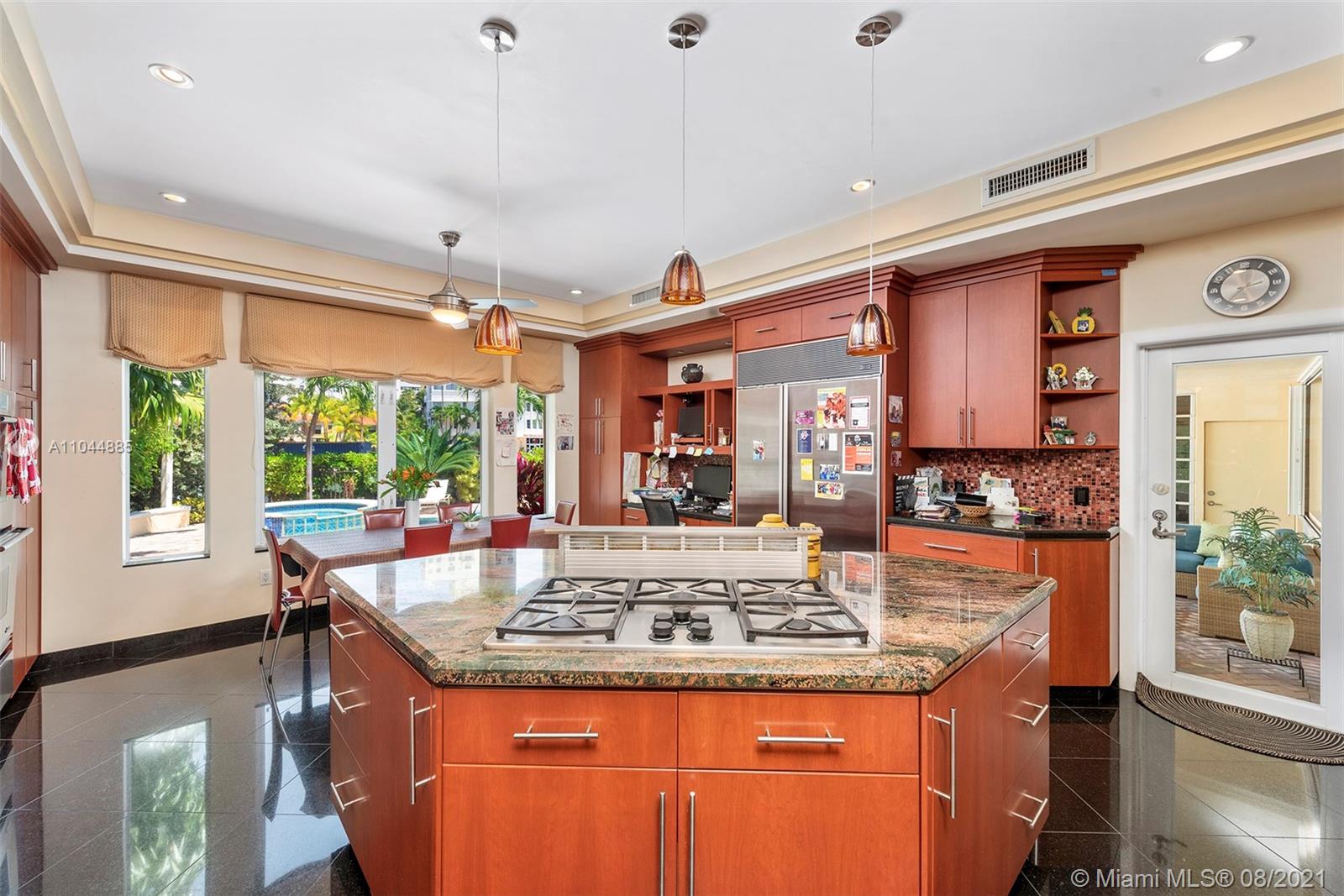 2995 Flamingo Drive Miami Beach, FL 33140 - Photo 29 of 54 a kitchen with kitchen island granite countertop a stove and a sink