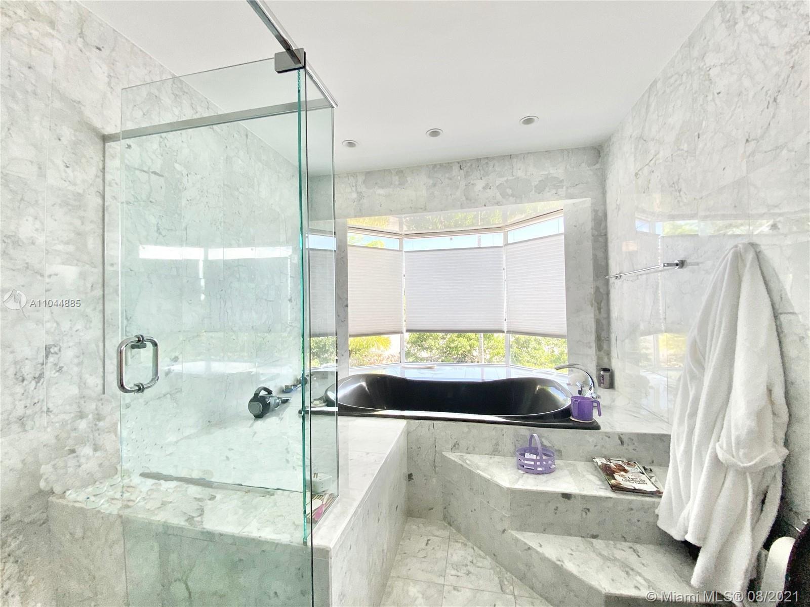 2995 Flamingo Drive Miami Beach, FL 33140 - Photo 39 of 54 a bathroom with a tub sink and window