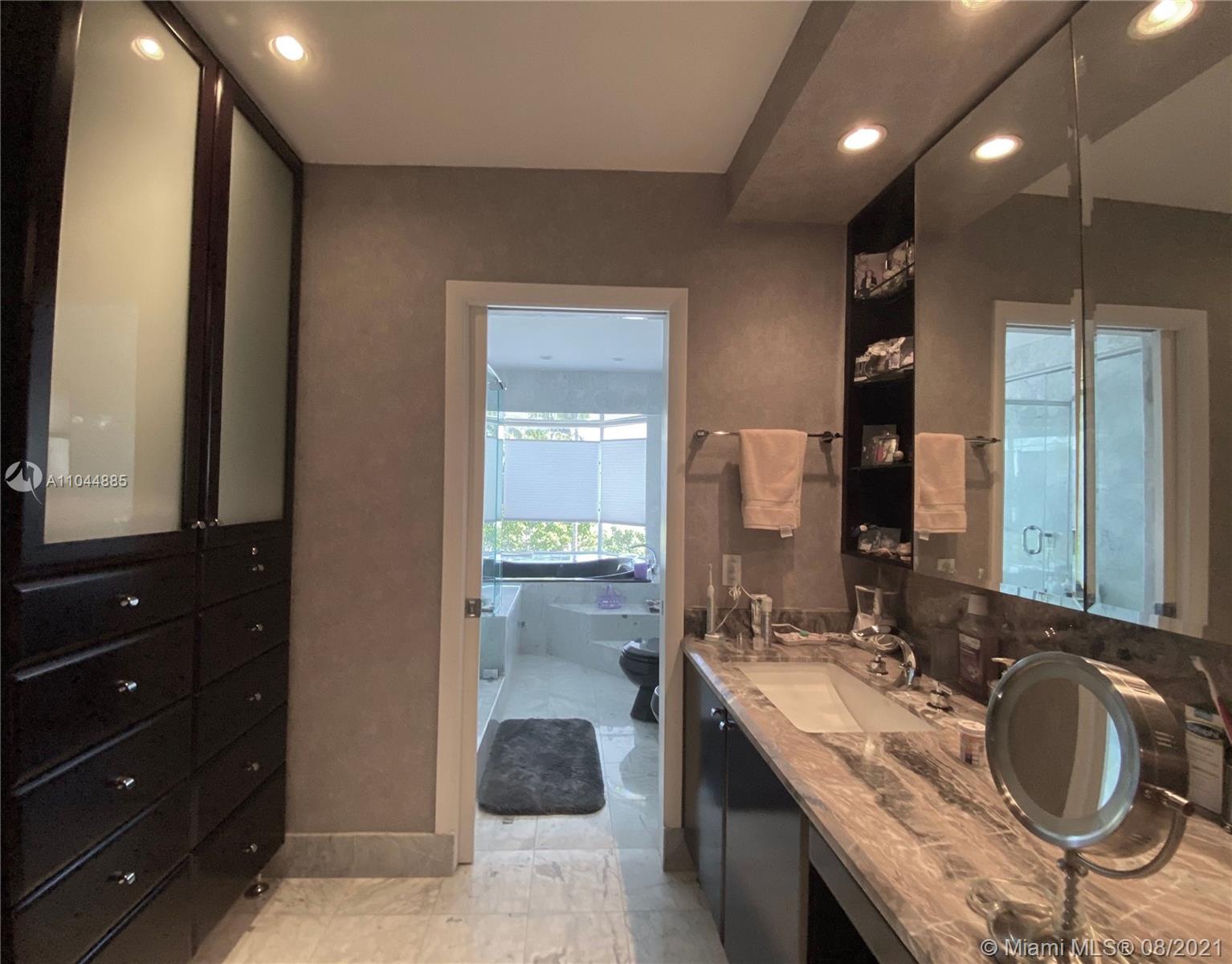 2995 Flamingo Drive Miami Beach, FL 33140 - Photo 41 of 54 a bathroom with a double vanity sink and a mirror