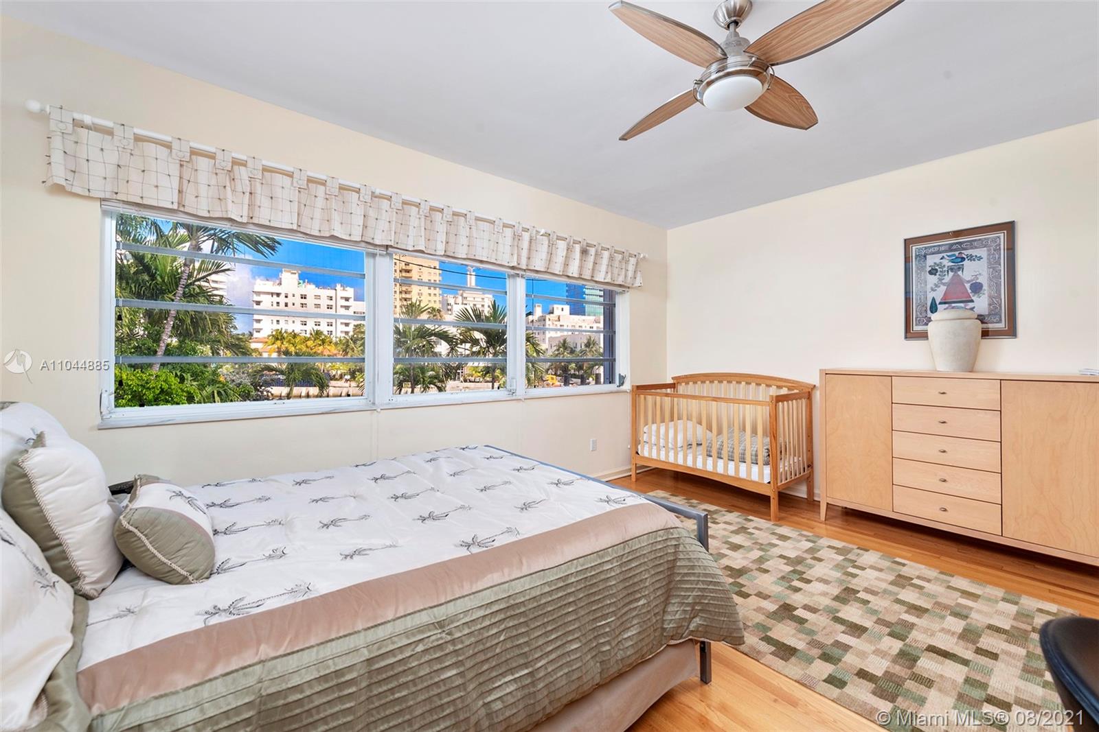 2995 Flamingo Drive Miami Beach, FL 33140 - Photo 42 of 54 a bedroom with a bed and wooden floor