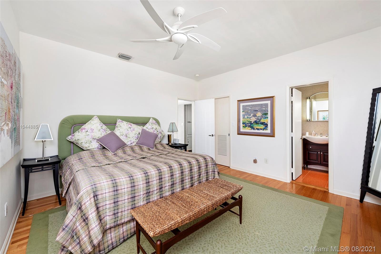 2995 Flamingo Drive Miami Beach, FL 33140 - Photo 47 of 54 a bedroom with a bed and wooden floor