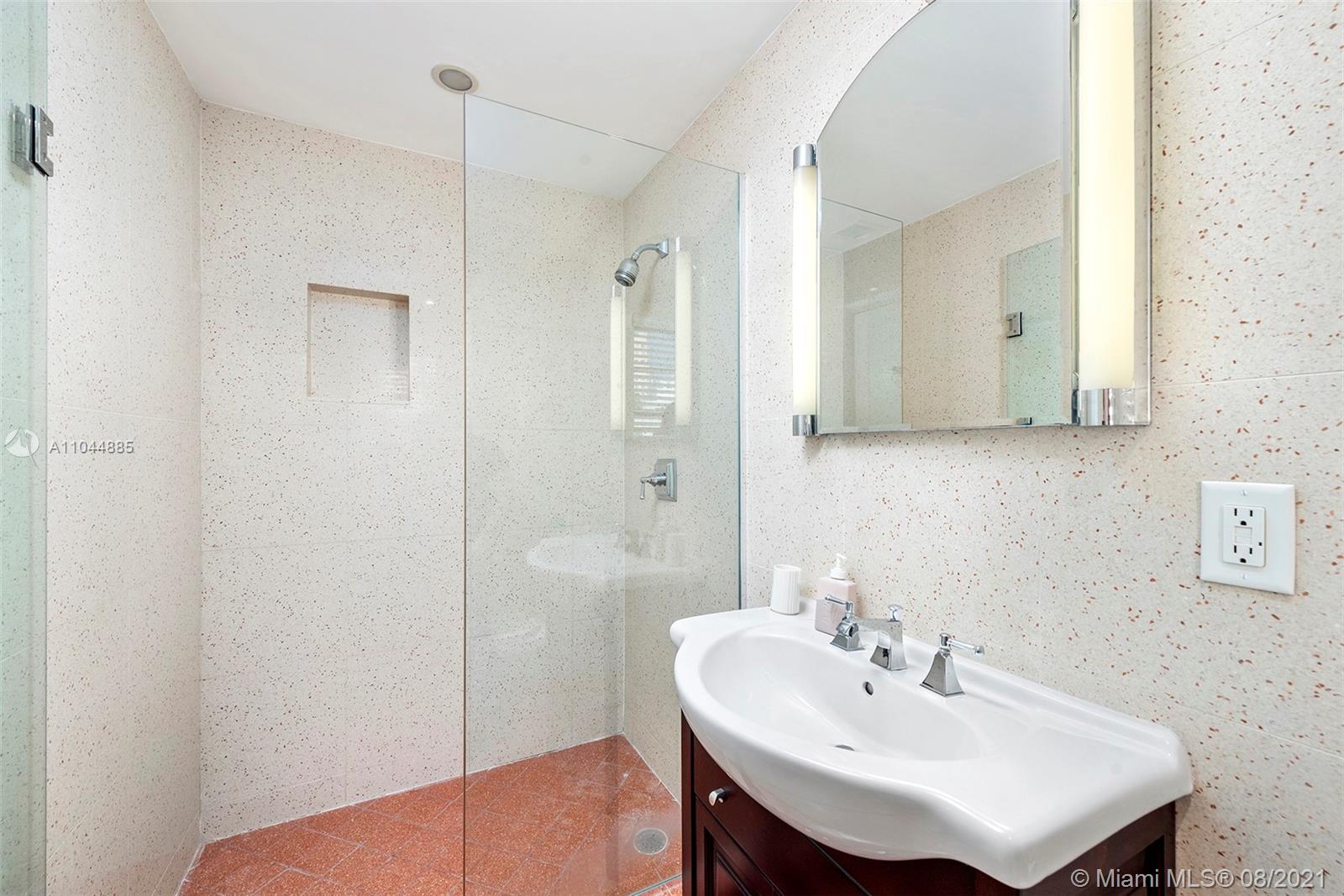 2995 Flamingo Drive Miami Beach, FL 33140 - Photo 48 of 54 a bathroom with a sink a shower and a mirror