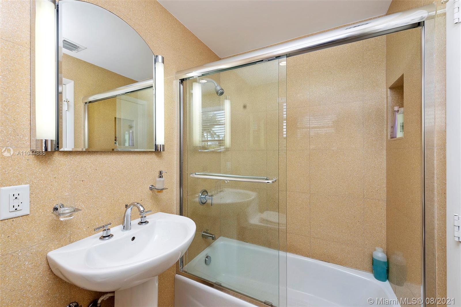 2995 Flamingo Drive Miami Beach, FL 33140 - Photo 51 of 54 a bathroom with a sink shower and a mirror