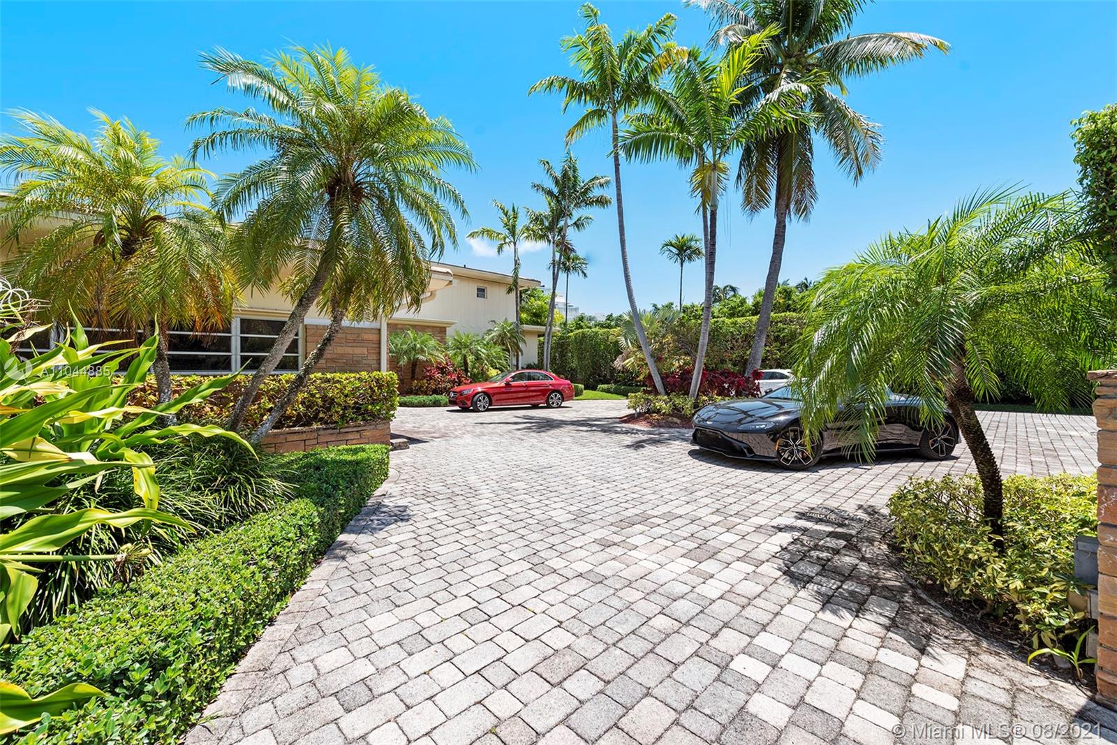 2995 Flamingo Drive Miami Beach, FL 33140 - Photo 9 of 54 a row of palm trees in front of house