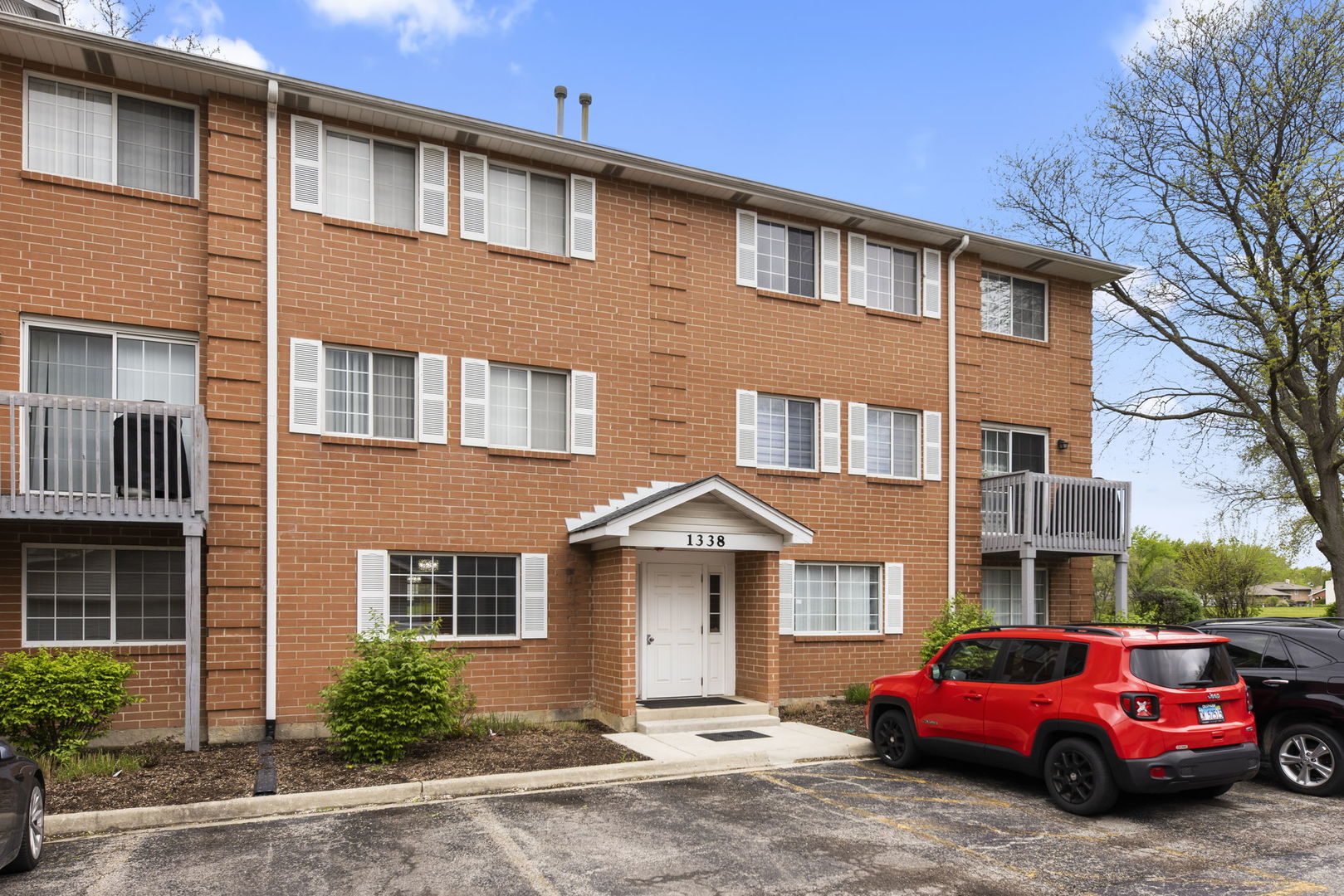1338 South Lorraine Road, Unit D Wheaton, IL 60189 - Photo 1 of 23 a front view of a house with a yard