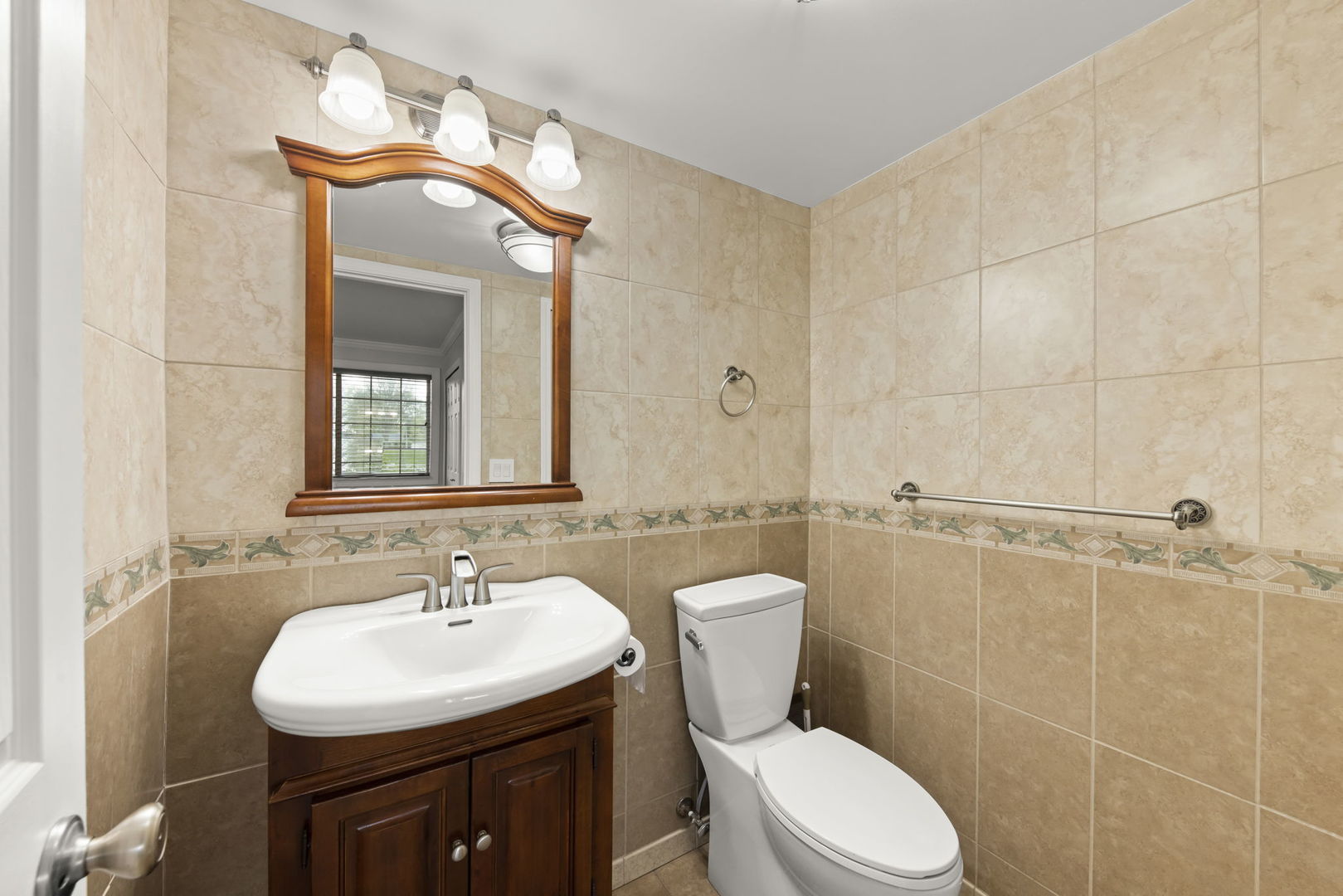 1338 South Lorraine Road, Unit D Wheaton, IL 60189 - Photo 17 of 23 a bathroom with a sink toilet mirror and shower