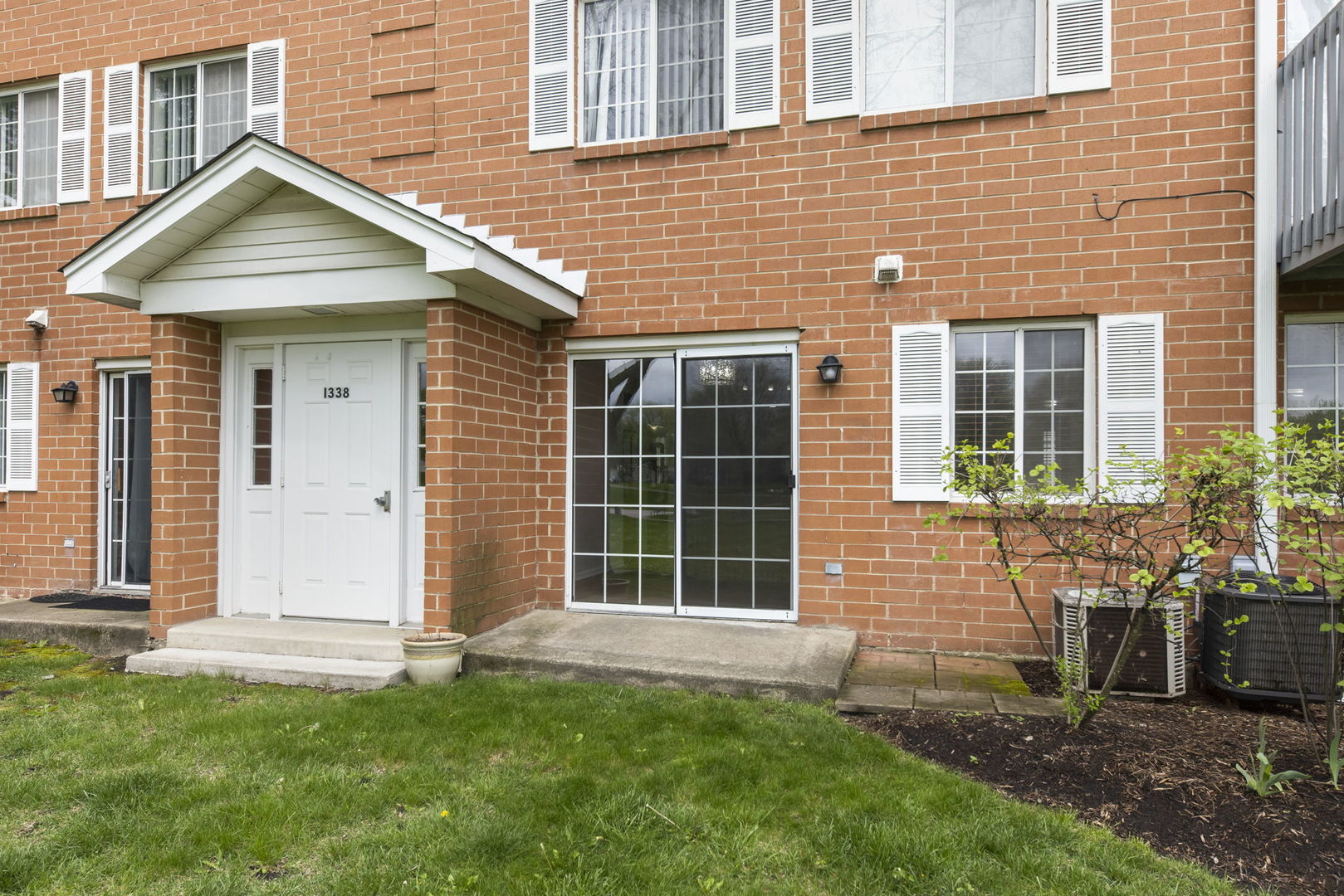 1338 South Lorraine Road, Unit D Wheaton, IL 60189 - Photo 21 of 23 front view of a house with a yard