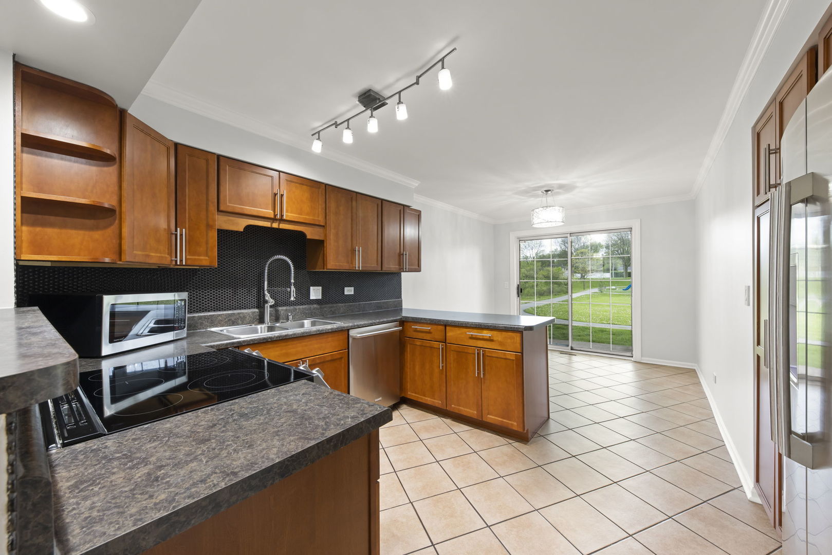 1338 South Lorraine Road, Unit D Wheaton, IL 60189 - Photo 7 of 23 a kitchen with stainless steel appliances granite countertop a sink stove and cabinets