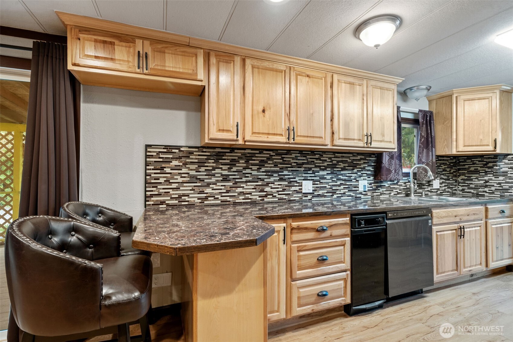 400 Gupster Road, Unit 1 Sequim, WA 98382 - Photo 13 of 39 a kitchen with granite countertop a sink stove and cabinets