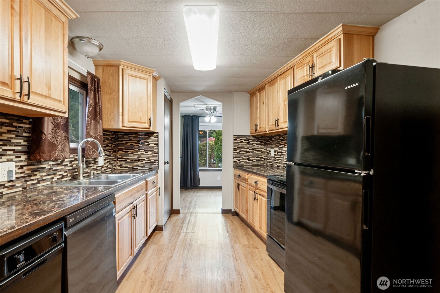 400 Gupster Road, Unit 1 Sequim, WA 98382 - Photo 15 of 39 a kitchen with granite countertop a refrigerator stove and sink