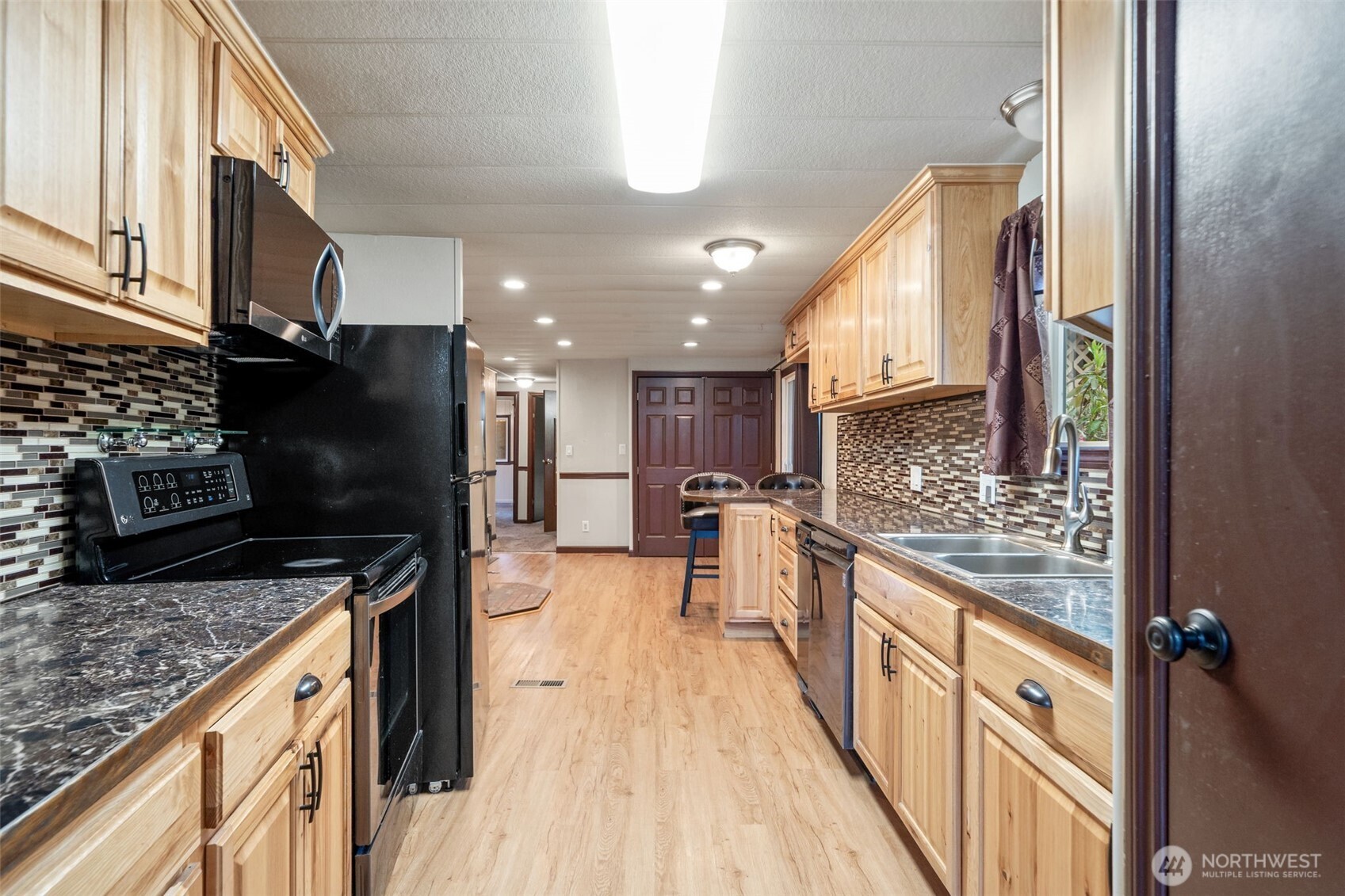 400 Gupster Road, Unit 1 Sequim, WA 98382 - Photo 16 of 39 a kitchen with stainless steel appliances granite countertop a refrigerator a stove top oven a sink and dishwasher