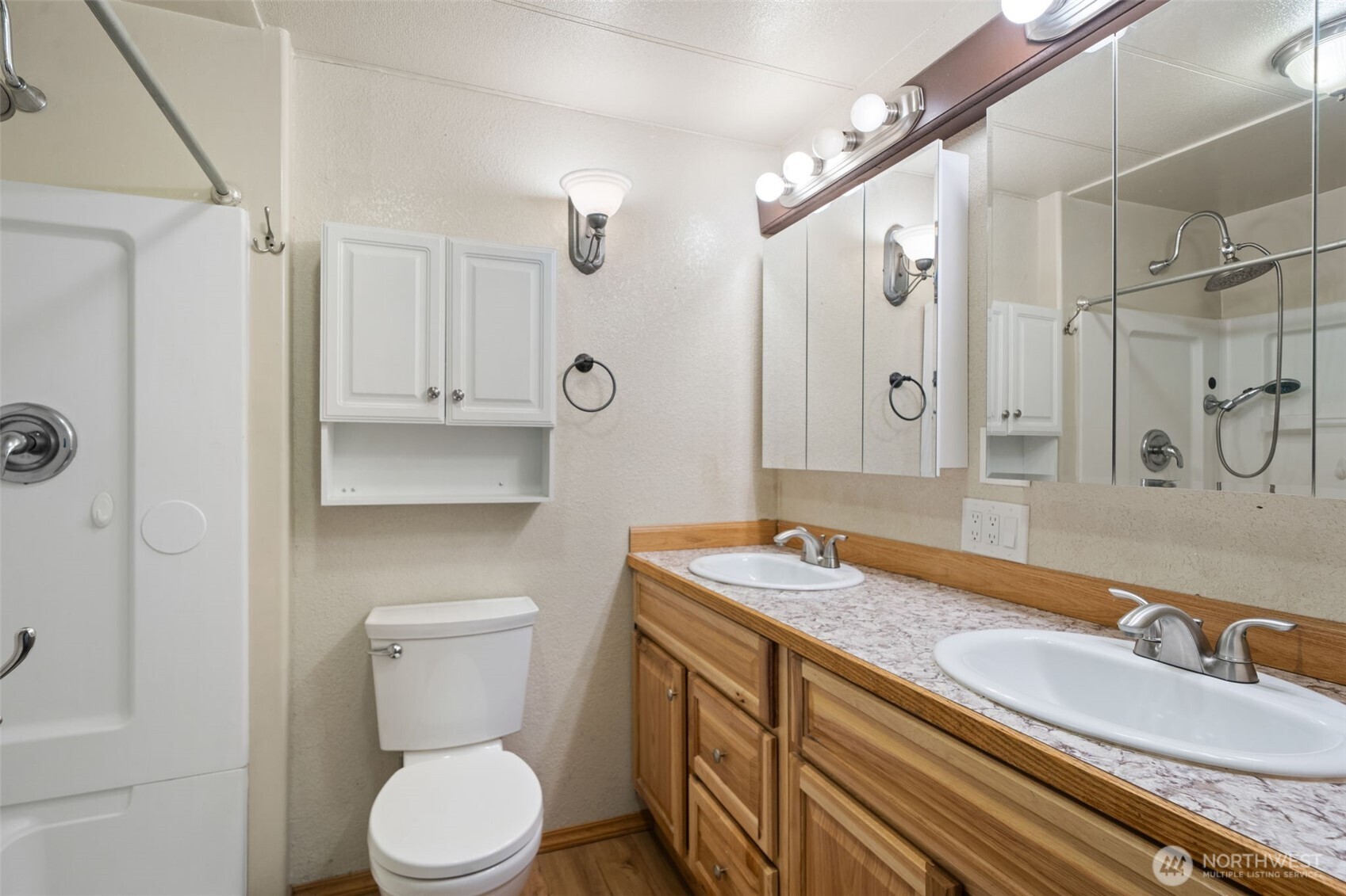 400 Gupster Road, Unit 1 Sequim, WA 98382 - Photo 25 of 39 a bathroom with a granite countertop sink a toilet a mirror and shower