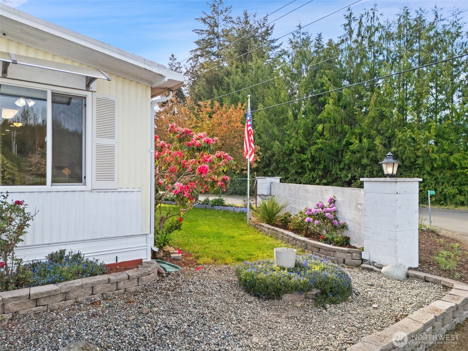 400 Gupster Road, Unit 1 Sequim, WA 98382 - Photo 31 of 39 a wooden fence with some potted plants in front of it