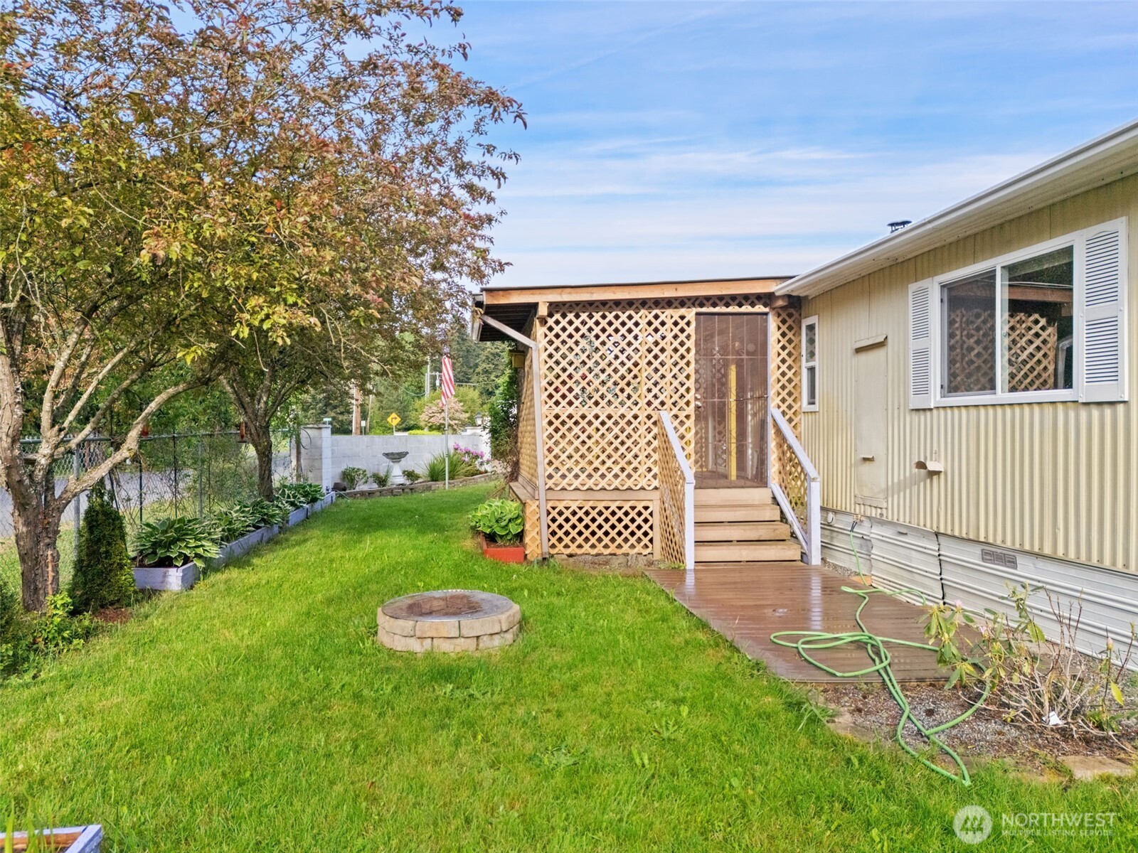 400 Gupster Road, Unit 1 Sequim, WA 98382 - Photo 35 of 39 a view of a backyard with couches plants and large tree