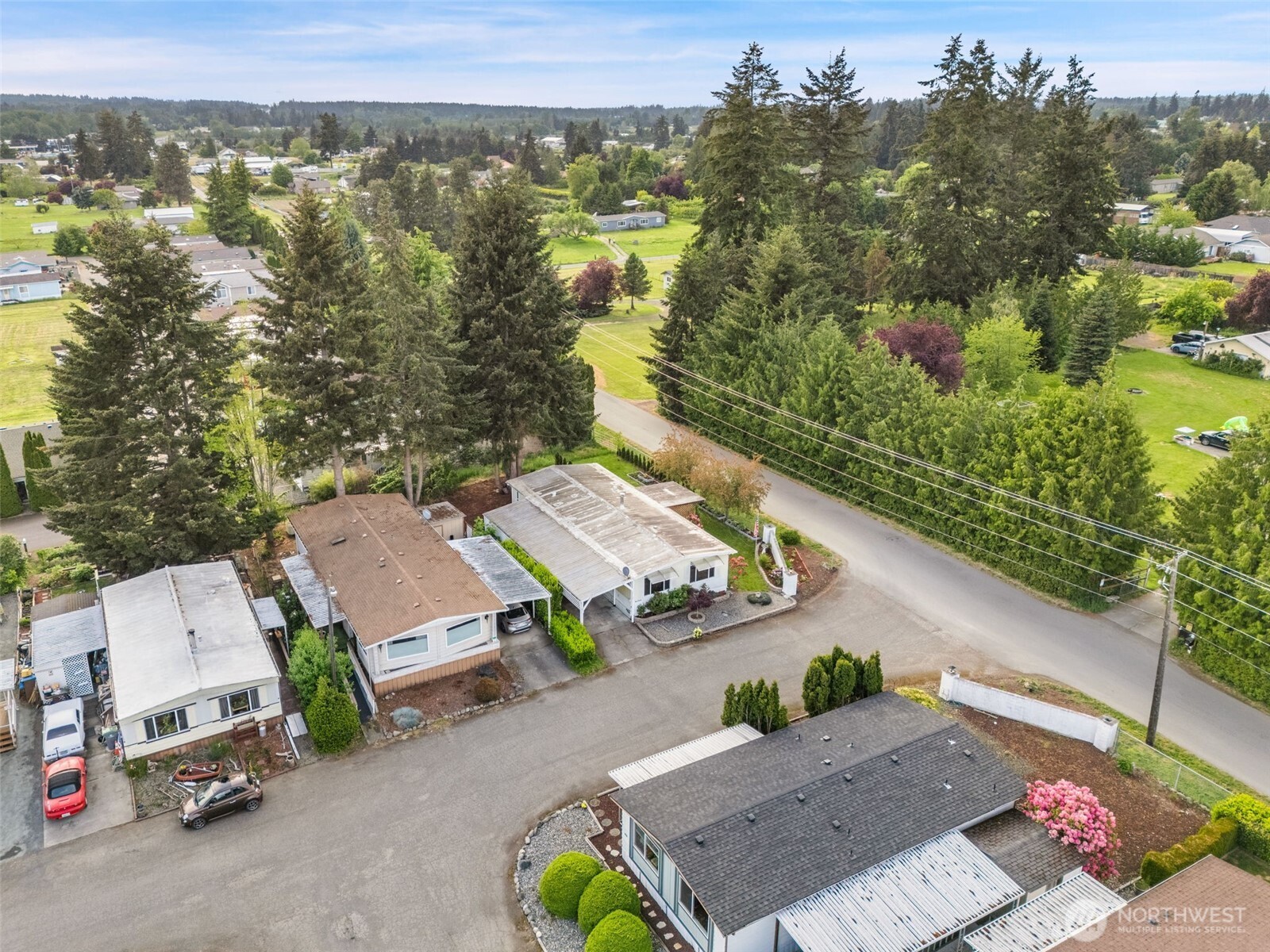 400 Gupster Road, Unit 1 Sequim, WA 98382 - Photo 37 of 39 an aerial view of multiple houses with outdoor space