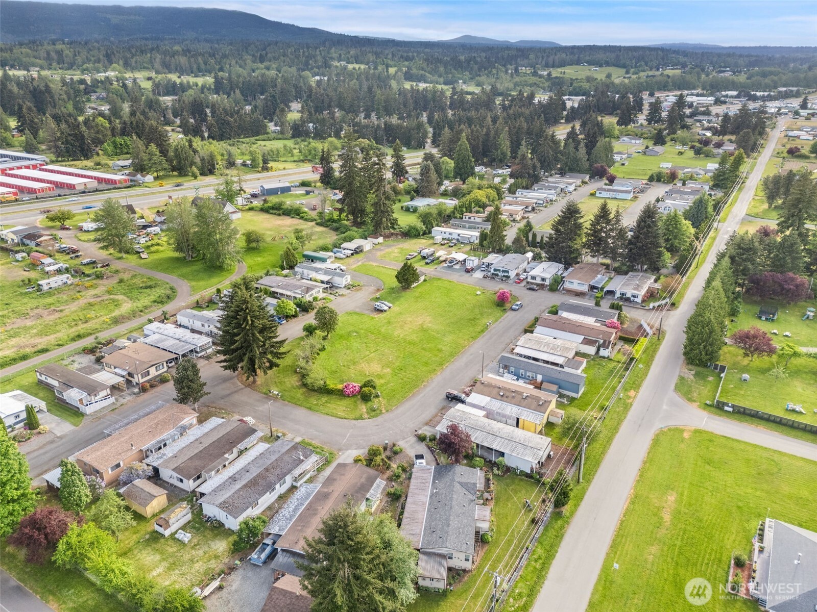400 Gupster Road, Unit 1 Sequim, WA 98382 - Photo 39 of 39 an aerial view of residential houses with outdoor space and river view