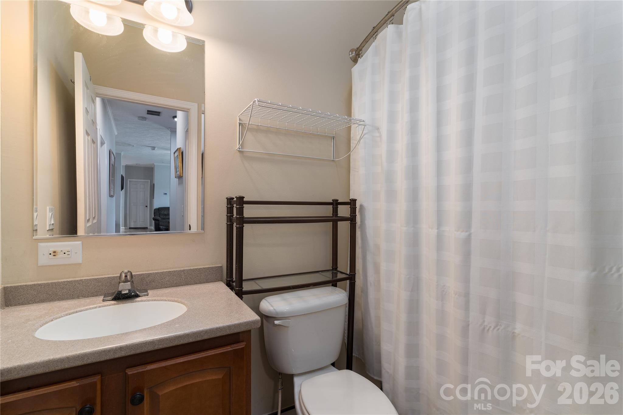 296 Stillwater Road Troutman, NC 28166 - Photo 22 of 33 a bathroom with a granite countertop sink toilet and mirror