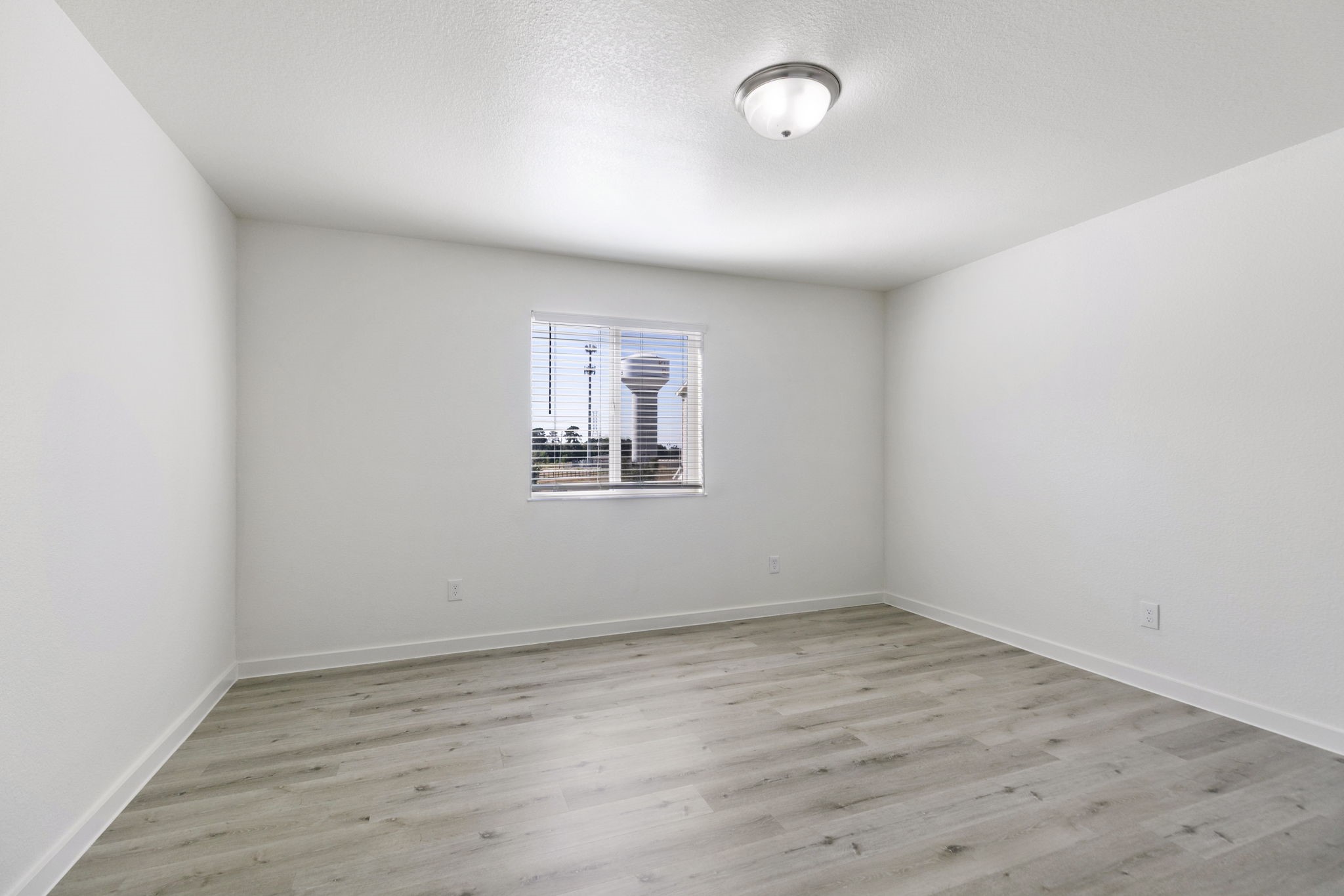 21155 Gosling Road, Unit 11B Spring, TX 77388 - Photo 11 of 27 an empty room with wooden floor and windows