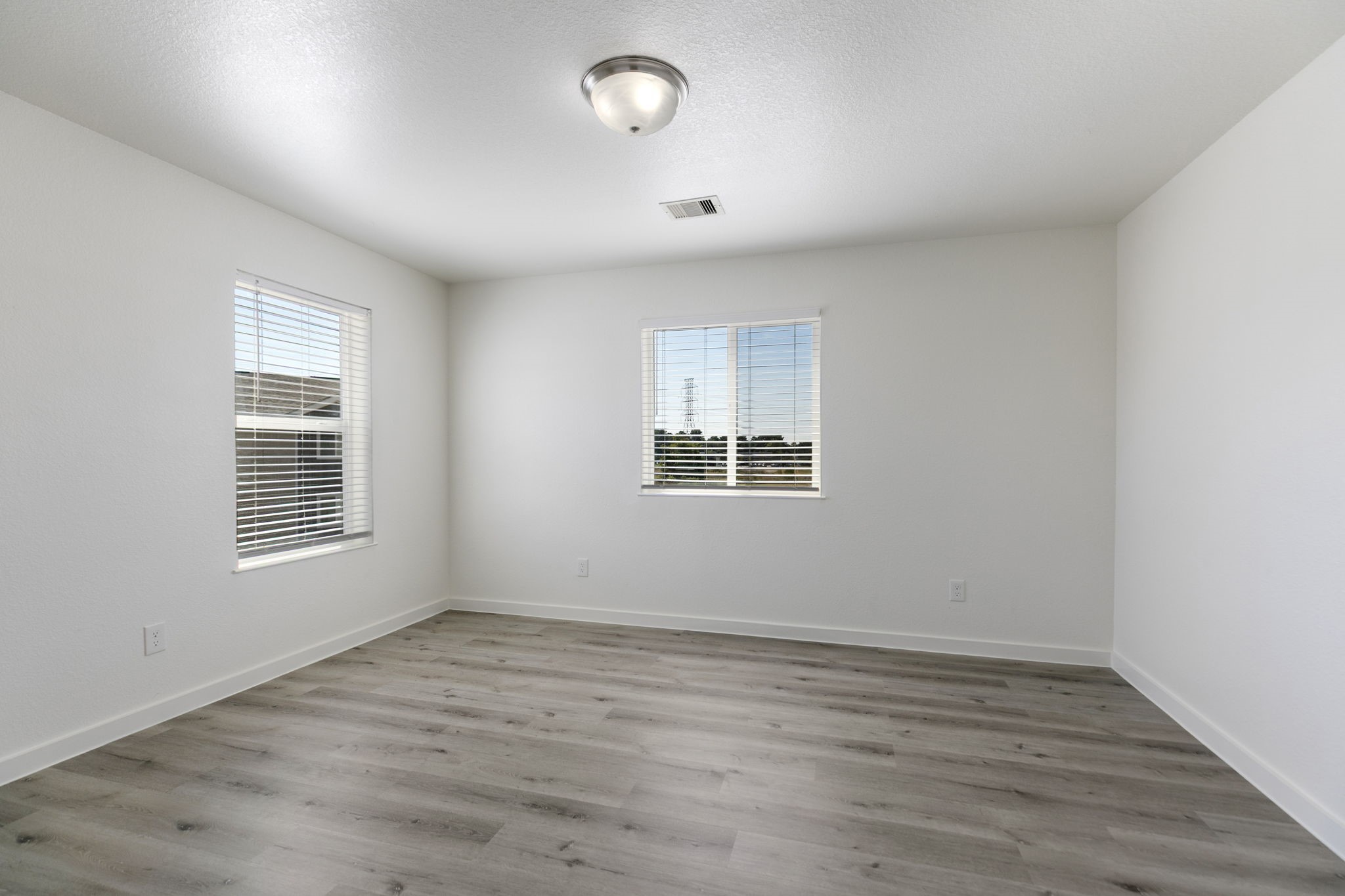 21155 Gosling Road, Unit 11B Spring, TX 77388 - Photo 16 of 27 an empty room with wooden floor and windows