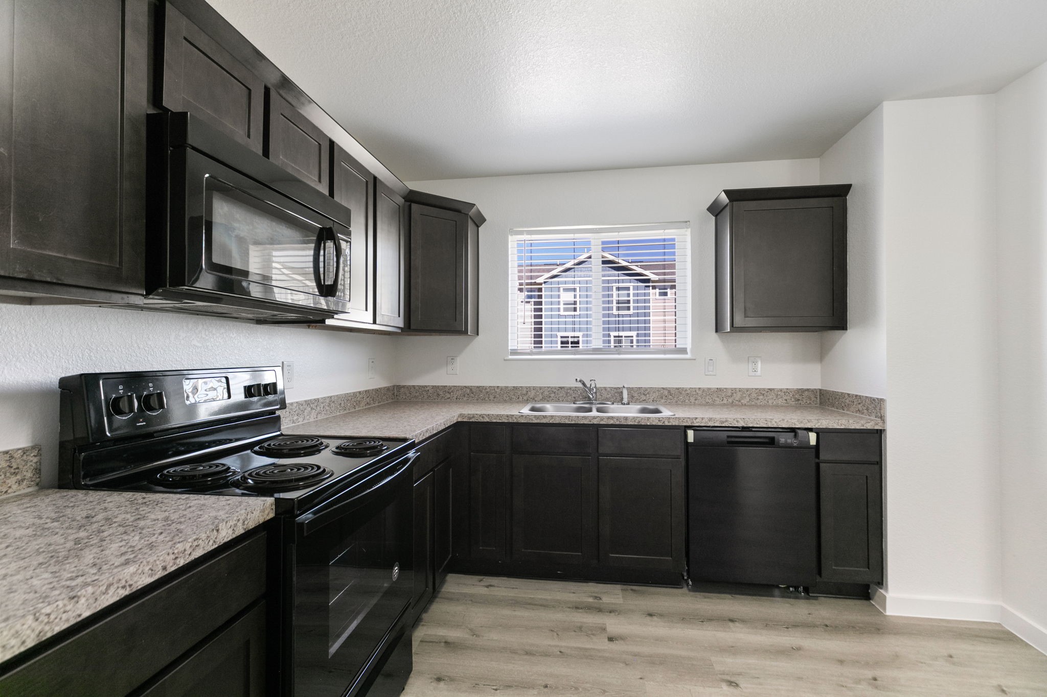 21155 Gosling Road, Unit 11B Spring, TX 77388 - Photo 9 of 27 a kitchen with a sink stove and microwave