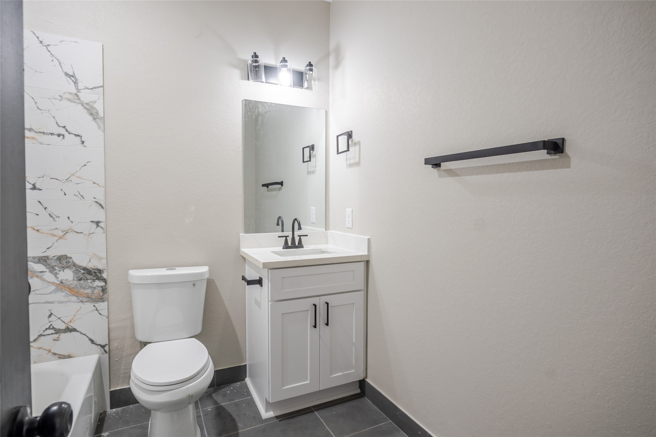 8707 Westcott Road, Unit A AND B Houston, TX 77016 - Photo 12 of 14 a bathroom with a toilet sink and mirror