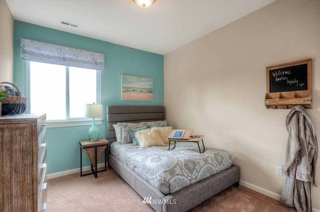 21127 Meridian Drive Southeast, Unit P23 Bothell, WA 98021 - Photo 13 of 40 a bedroom with a bed and a window