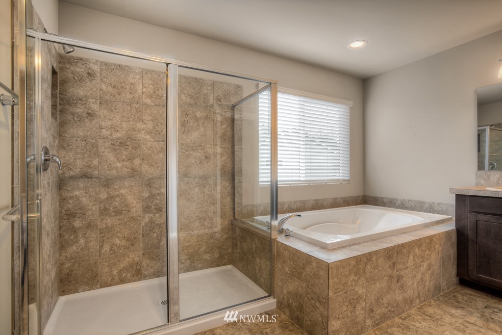 21127 Meridian Drive Southeast, Unit P23 Bothell, WA 98021 - Photo 37 of 40 a bathroom with a tub sink and shower