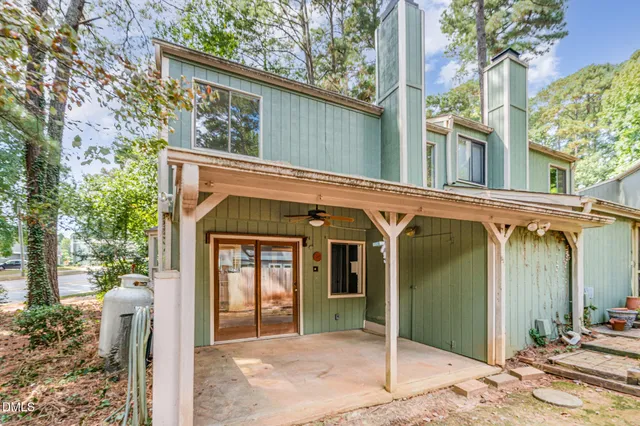 a view of a house with a porch and furniture