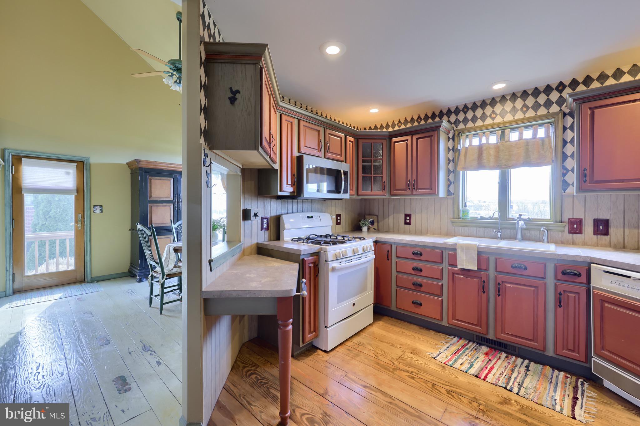 65 South Reamstown Road Stevens, PA 17578 - Photo 17 of 55 a kitchen with stainless steel appliances kitchen island granite countertop a stove refrigerator and cabinets