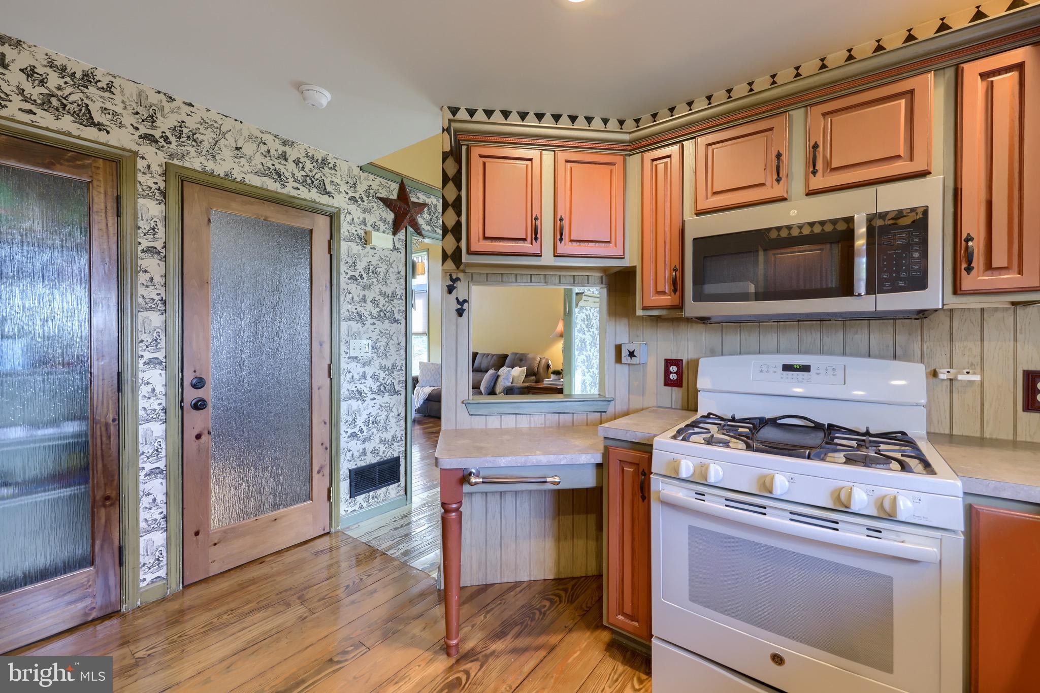 65 South Reamstown Road Stevens, PA 17578 - Photo 20 of 55 a kitchen with stainless steel appliances granite countertop a stove a microwave and a refrigerator