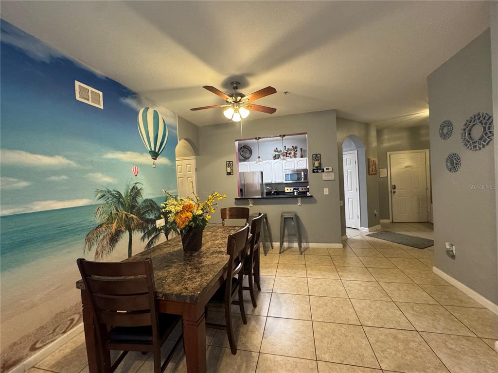 7664 Comrow Street, Unit 204 Kissimmee, FL 34747 - Photo 5 of 17 a view of a dining room with furniture and chandelier