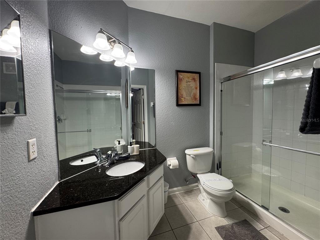 7664 Comrow Street, Unit 204 Kissimmee, FL 34747 - Photo 9 of 17 a bathroom with a sink a toilet and shower