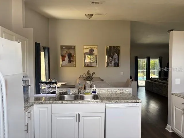 a bathroom with double sink and a mirror