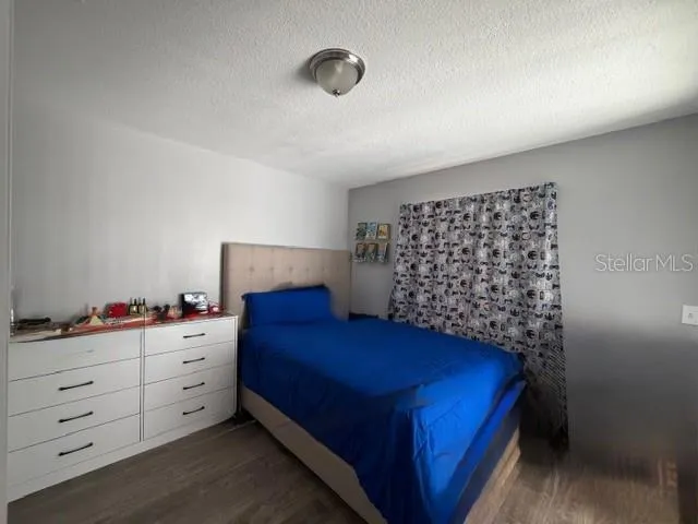 a bedroom with a bed and a dresser