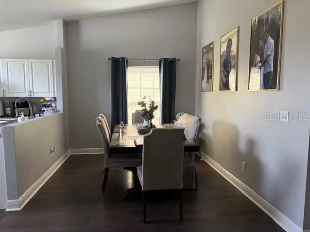 a dining room with furniture and window