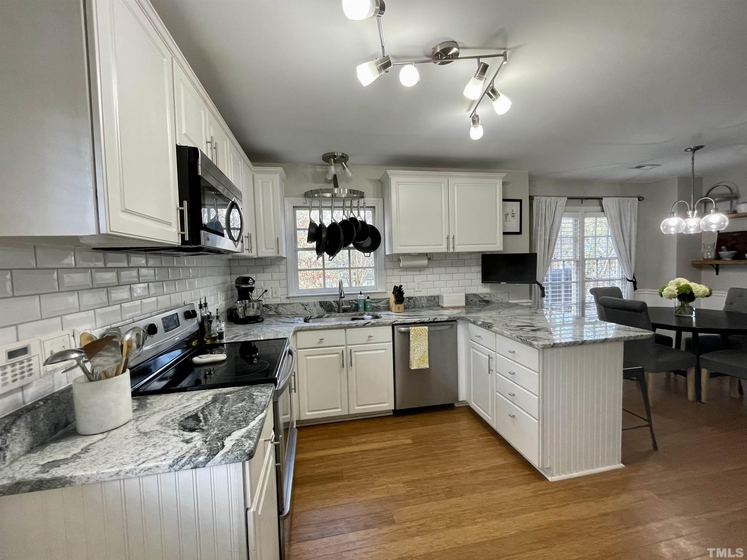 2908 Laura Duncan Road Cary, NC 27513 - Photo 2 of 8 a kitchen with kitchen island granite countertop a sink cabinets and stainless steel appliances