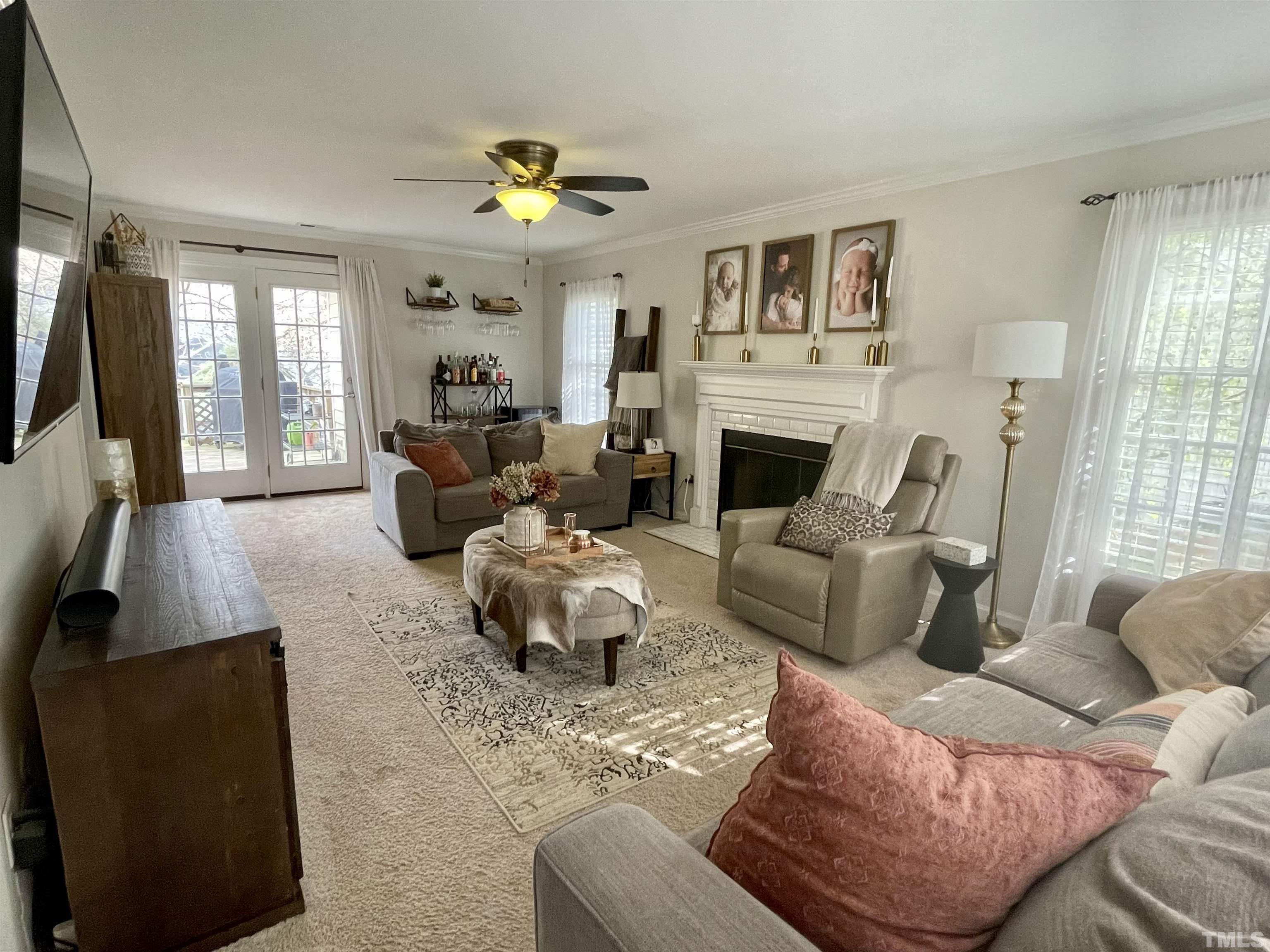 2908 Laura Duncan Road Cary, NC 27513 - Photo 5 of 8 a living room with furniture window and a fireplace