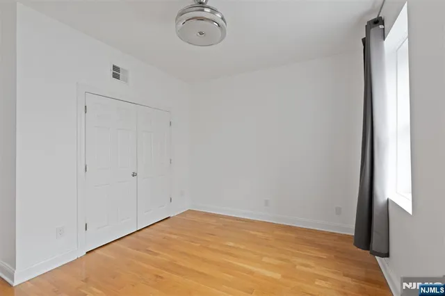 a view of empty room with a fan