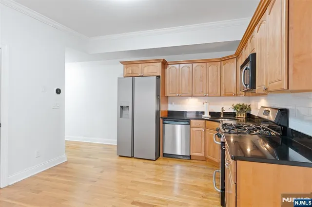 a kitchen with granite countertop a refrigerator and a stove