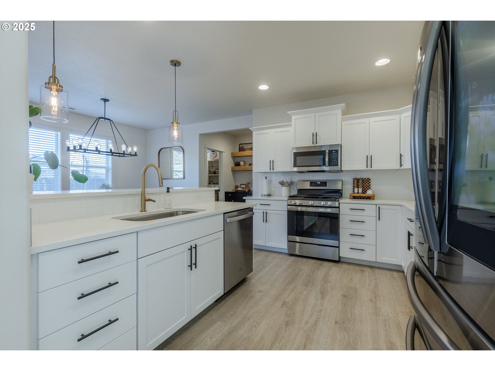 782 South 52nd Street Springfield, OR 97478 - Photo 12 of 41 a kitchen with stainless steel appliances kitchen island granite countertop a stove a sink and a refrigerator