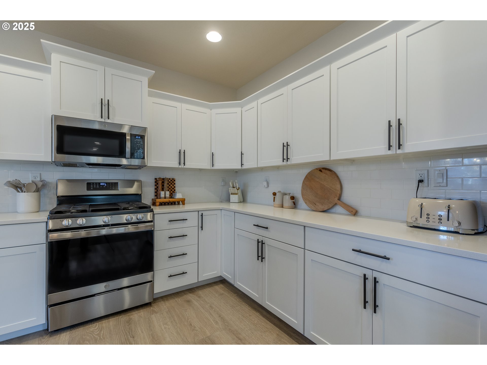 782 South 52nd Street Springfield, OR 97478 - Photo 13 of 41 a kitchen with stainless steel appliances granite countertop a stove a sink and a white cabinets