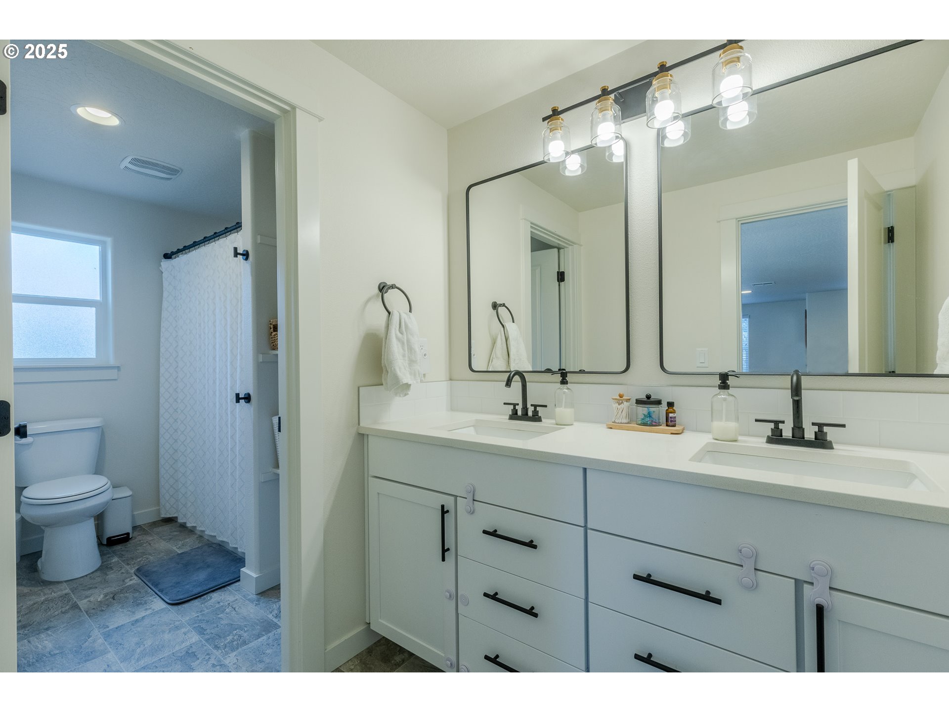 782 South 52nd Street Springfield, OR 97478 - Photo 26 of 41 a bathroom with a toilet a sink a mirror and vanity